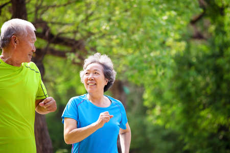 Asian Senior Couple jogging in the nature park