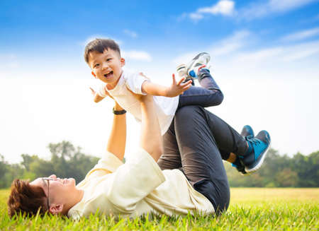 Happt Father and son playing in the parkの写真素材