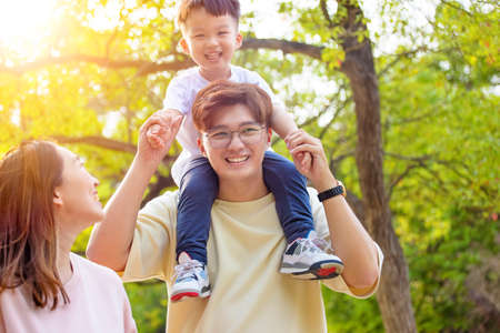 happy family walking in the parkの写真素材
