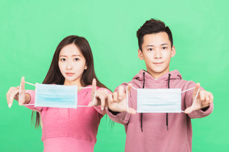 Young couple wearing protective face mask. Flu and coronavirus prevention conceptの写真素材