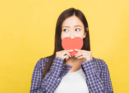 young woman holding in hands small little heartの写真素材