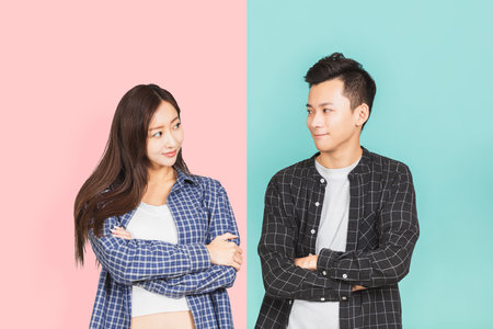 smiling young asian couple looking on each other