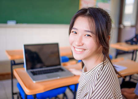 Portrait of asian cute student teenager girl in classroomの写真素材