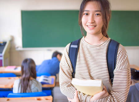 Portrait of asian cute student teenager girl in classroomの写真素材