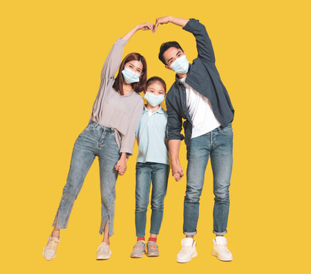 Happy family smiling and hugging on the couch at homeの写真素材