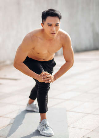 Handsome sportive man doing workout outdoorの写真素材