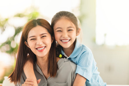 Happy mother and little girl daughter having fun at homeの写真素材