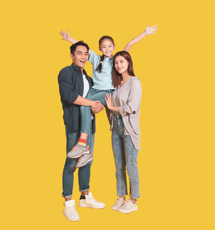 Happy Asian young family with one child standing embracing and smilingの写真素材