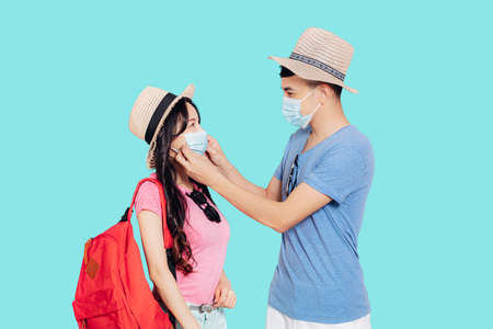 Young Couple in face masks for travel at summer