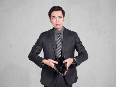 young businessman holding a medical mask. During the  epidemic, he should always wear the mask by his sideの写真素材