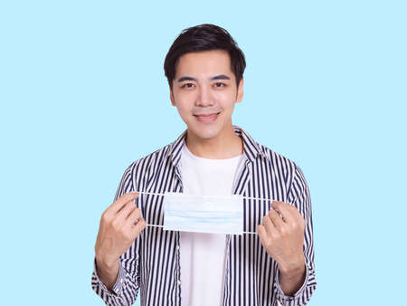 young man smiling and making thumbs up gesture