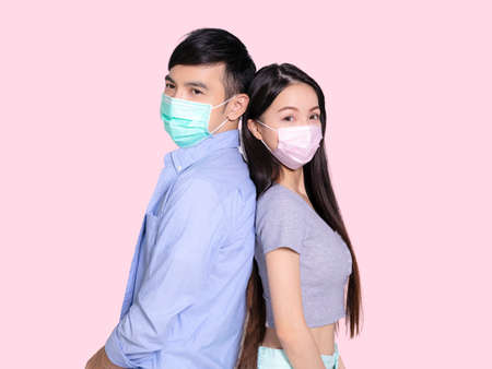 Young couple kissing from the screen of their smartphones.の写真素材