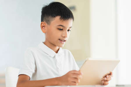 Boy looking at tablet.Study online.Watching video.の写真素材