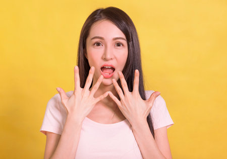 Shocked excited Beautiful Asian woman with mouth openの写真素材