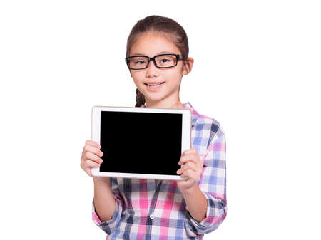 Happy student girl with glasses showing tablet.Isolated on white background.の写真素材