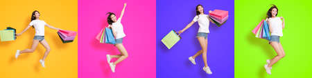 Young woman carrying shopping bags and jumping