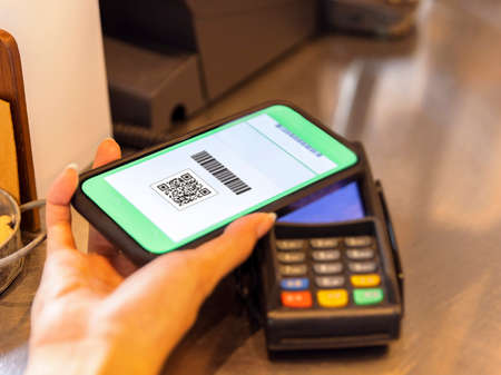 customer using wireless or contactless payment of a smart phone.