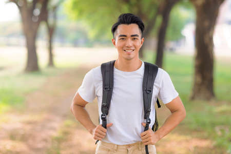 Smiling asian young man looking at cameraの写真素材