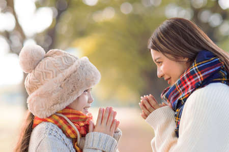 Mother with child having fun in autumn parkの写真素材