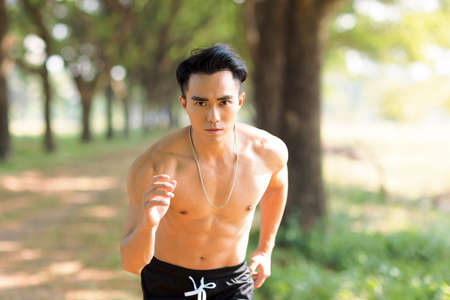 Fittness asian man doing exercises in the parkの写真素材