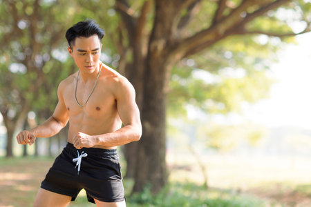 Young man doing exercises in the parkの写真素材