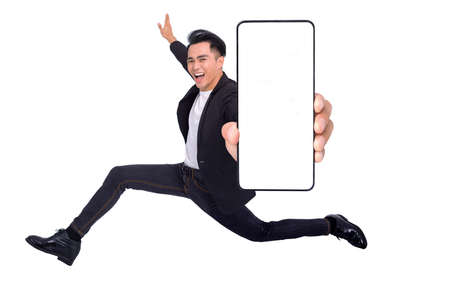 Happy young man running and showing big Smartphone With Blank White Screenの写真素材
