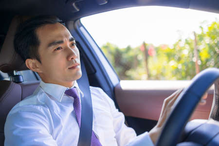 Handsome young man driving a carの写真素材