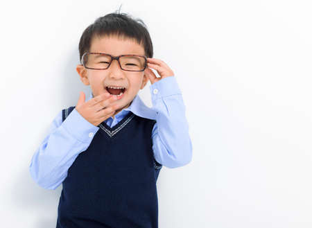 Happy Kid boy holding glasses and having funの写真素材