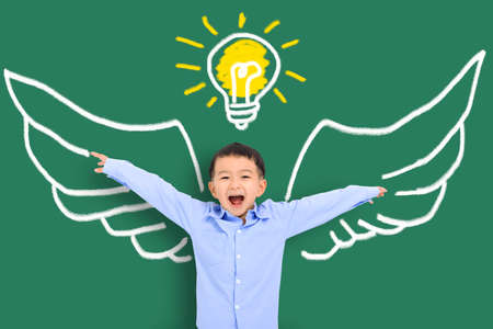 Smart kid with wing in class. Imagination, idea and success conceptの写真素材