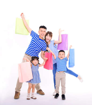 Happy family carrying shopping bag and hands up isolated on whiteの写真素材