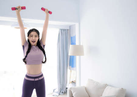 Young Asian healthy woman workout at home, home fitness concept