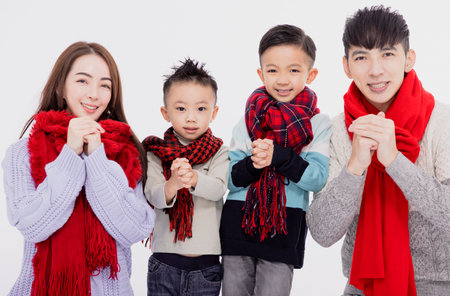 Happy asian family showing congratulation gesture for celebrating Chinese new yearの写真素材