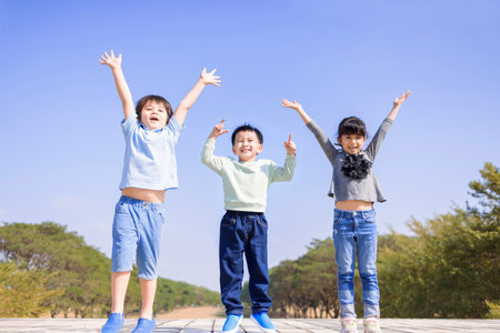 Happy children jumping and dancingの写真素材