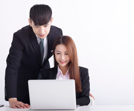 Business team using laptop and working together in officeの写真素材