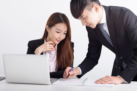 Business team using laptop and working together in officeの写真素材