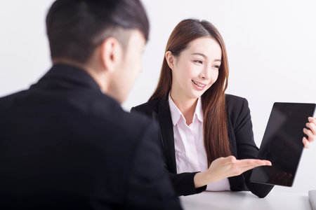 Businesswoman showing business plan with digital tablet pad in the officeの写真素材