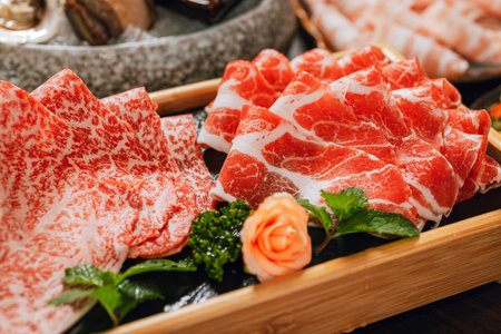Premium Rare Slices pork with high-marbled texture on circle wooden plate served for hot pots and Shabu.の写真素材