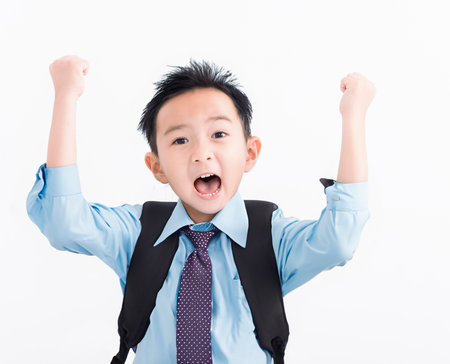 Happy Boy in student uniform isolated on white backgroundの写真素材