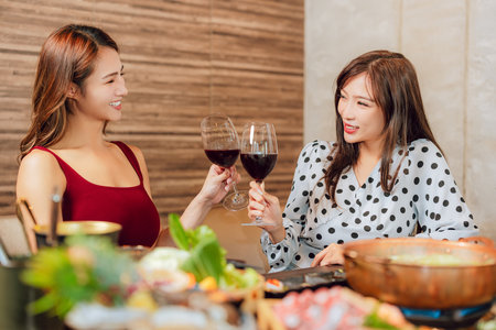 girlfriends raise a toast with glassesの写真素材