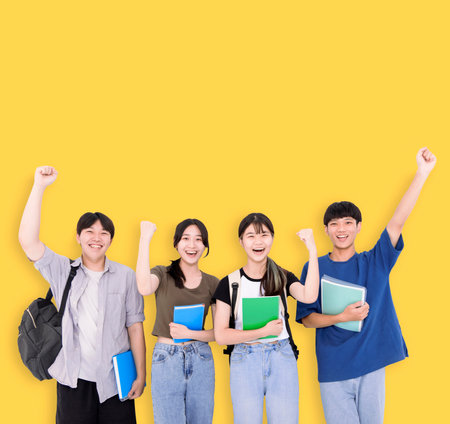 Group of stylish teenager students on yellow backgroundの写真素材