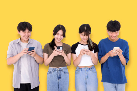 Group of stylish students using mobile phoneの写真素材