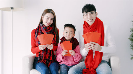 happy chinese new year. asian family showing red envelope for celebrating chinese new yearの写真素材