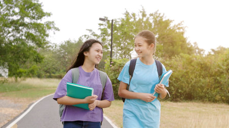 Happy student girls walking and talking in the schoolの写真素材