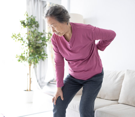 senior woman with pain in back and kneeの写真素材
