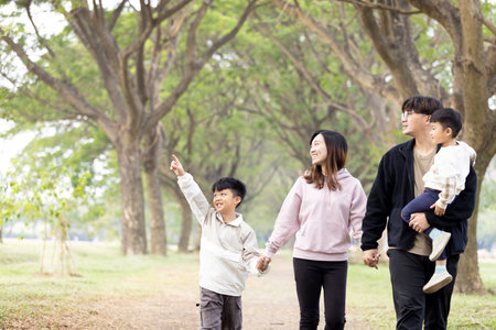 Happy Asian Family walking in the parkの写真素材