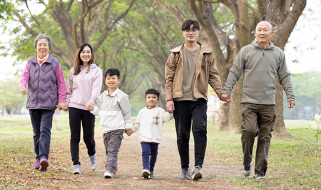 Happy Asian Family walking in the parkの写真素材