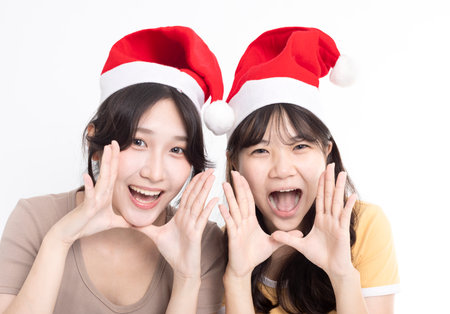 Girls in Santa's caps having funの写真素材