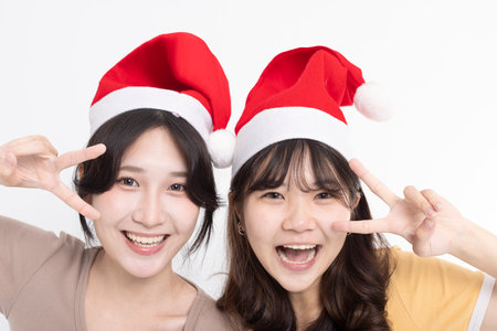 Girls in Santa's caps having funの写真素材