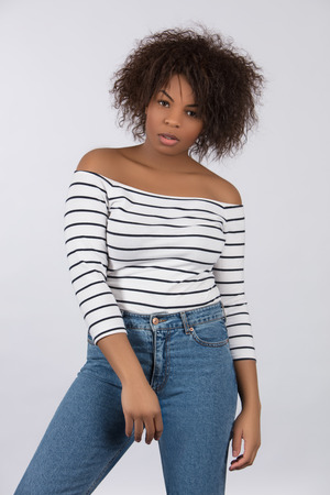 A studio image of a beautiful young black model shot against a plain backgroundの写真素材
