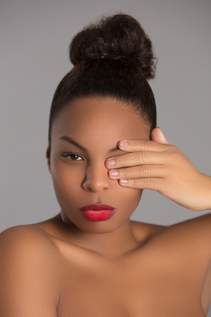 A studio image of a beautiful young black model shot against a plain backgroundの写真素材
